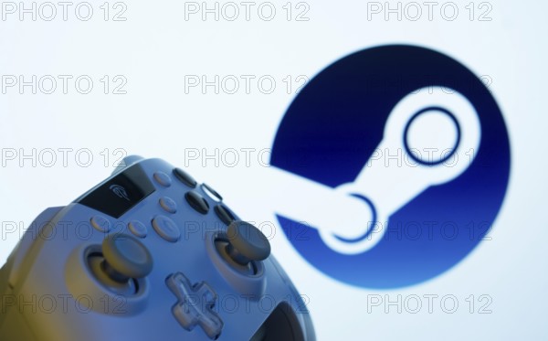 A close-up of a gamepad with the Steam seen on screen in the background