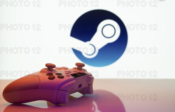 Game controller in front of Steam logo on a white background