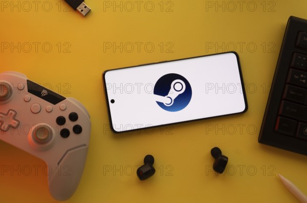 Smartphone with Steam logo, game controller, and earbuds on a yellow background