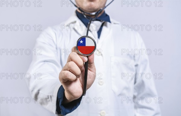 Doctor hands holding stethoscope with Chile flag. Chile health and care concept