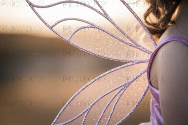Close up of beautiful purple fairy wings on child. Magical costume detail concept. Generative AI, AI generated