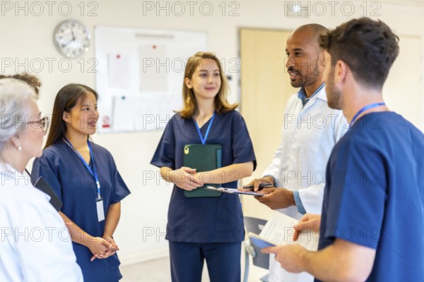 Diverse medical professionals collaborating, sharing expertise, and reviewing patient information during a productive meeting in a hospital setting