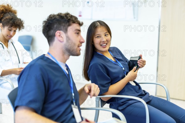 Group of medical professionals attending a conference, actively engaging in discussion and learning