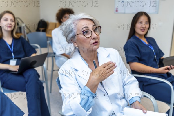 Experienced doctor leading a medical conference, actively engaging with her colleagues by explaining a topic with expressive hand gestures