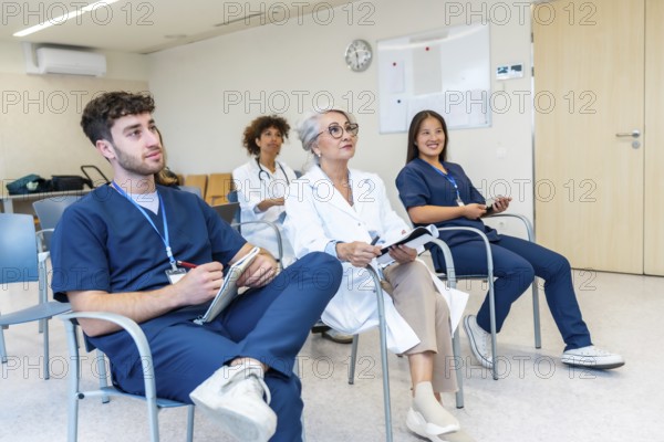 Healthcare professionals listening attentively during a medical conference, taking notes and expanding their knowledge