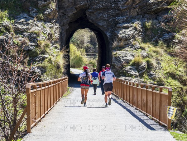 People on the Tranvía de Sierra Nevada, former railroad track, leading to the trail Vereda de la Estrella, Sierra Nevada, Andalusia, Spain