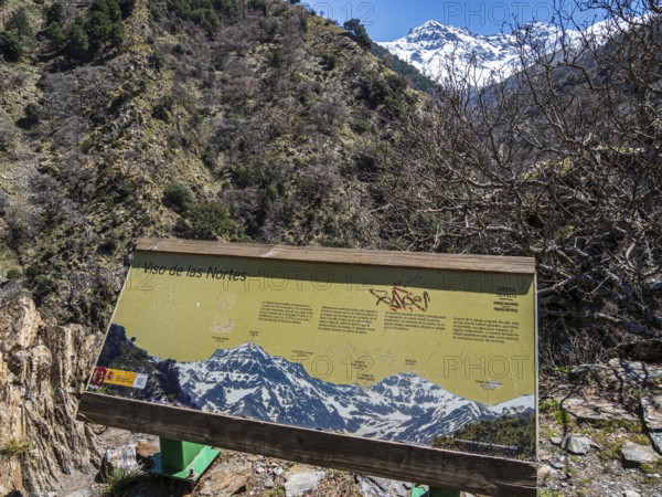 Information board, hiking trail Vereda de la Estrella, snow-covered mountain range in early spring, Sierra Nevada, Andalusia, Spain