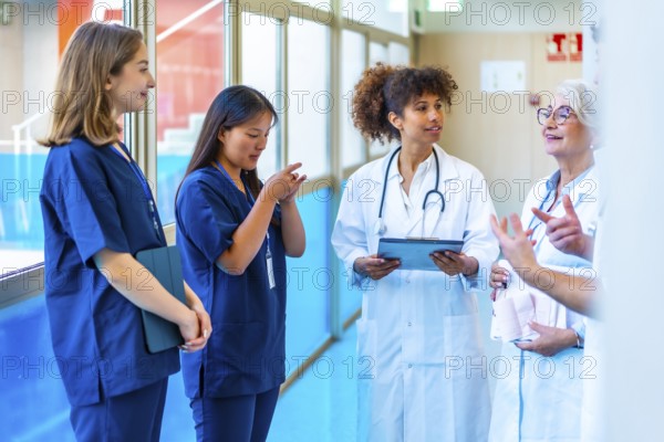 Doctors and nurses having a discussion about a patient's medical records in a hospital hallway