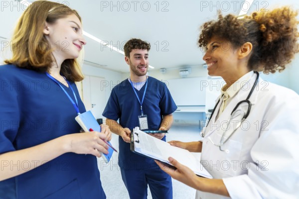 Doctor and nurses reviewing medical records, collaborating on patient care in a bright hospital setting