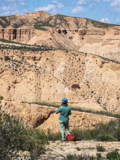 Cyclist looks over the desert, viewpoint, Gorafe Desert, UNESCO Granada Geopark, Granada province, Andalusia, Spain