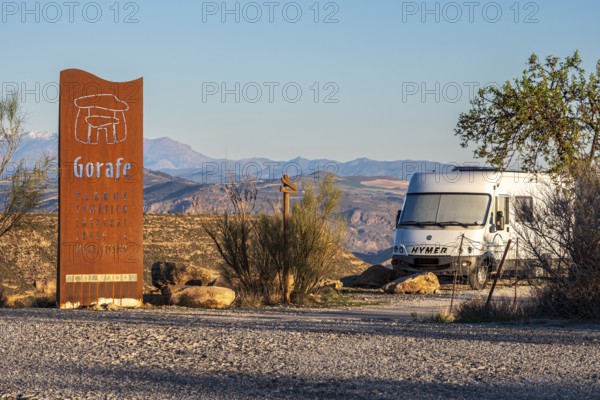 Signpost at the Gorafe megalithic park, camper van, Gorafe desert, Andalusia, Spain