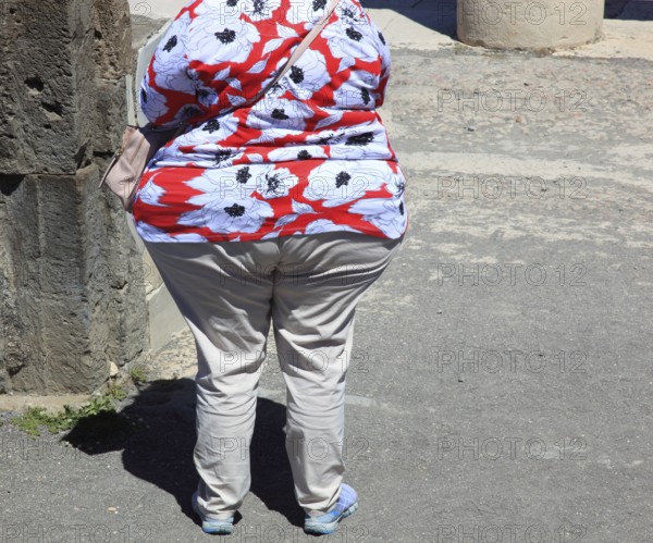 Overweight woman photographed from behind