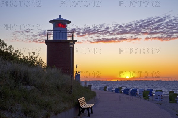 Olhörn lighthouse at colourful sunrise over the sea on the North Frisian island of Föhr, Schleswig-Holstein, Germany
