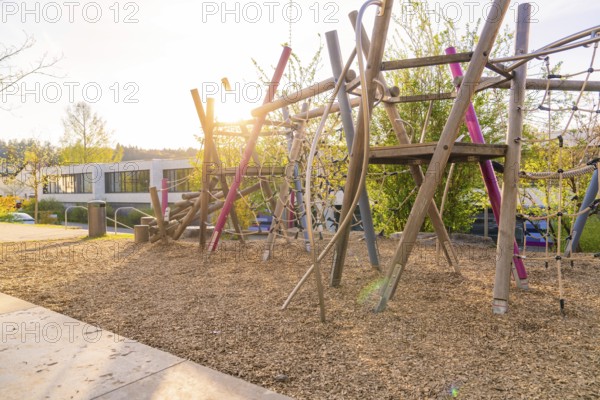 Sunlit playground with wooden climbing structures, Christiane Herzog Realschule, Nagold, district of Calw, Germany