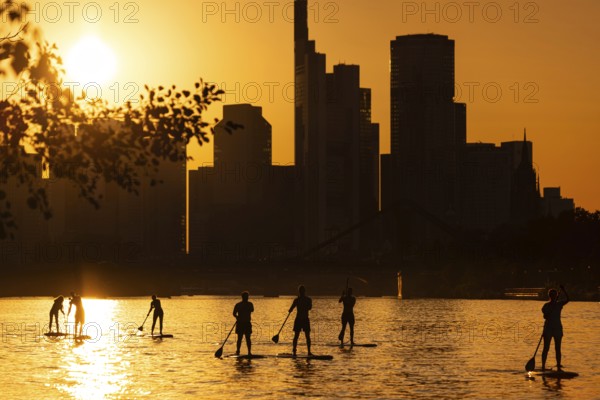 The sun sets behind the Frankfurt banking skyline, Frankfurt am Main, Hesse, Germany