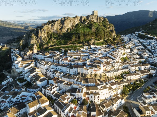 The White Town of Zahara de la Sierra below a Moorish castle. Aerial view. Drone shot. Cádiz province, Andalusia, Spain