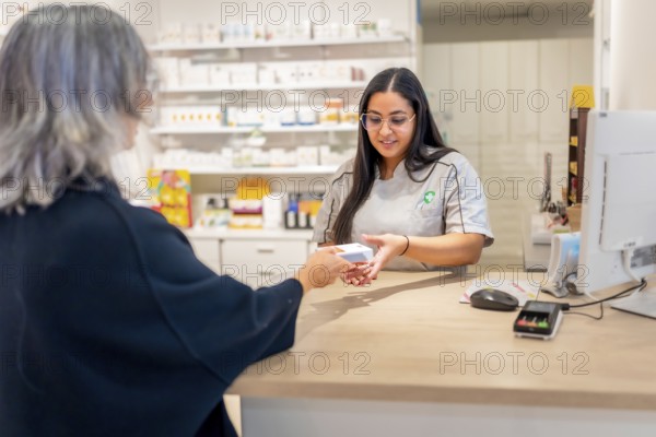 Rear view of a mature caucasian woman shopping in a modern pharmacy store