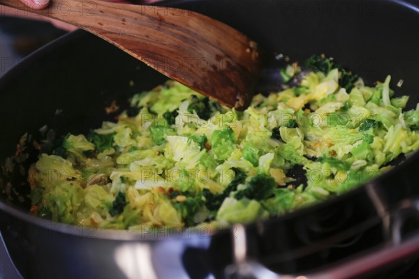 Swabian cuisine, preparation savoy cabbage, wild boar medallions with savoy cabbage cakes, sautéing vegetables, pan, spatula, healthy, home cooking, typical Swabian, traditional cuisine reinterpreted, food photography, studio, Germany
