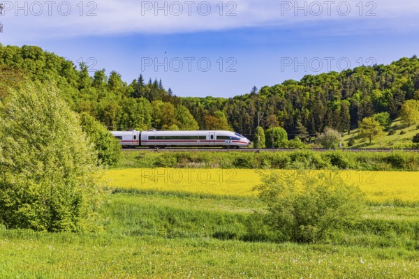 InterCityExpress ICE travelling across the Swabian Alb. Idyllic landscape in spring. Lonsee, Baden-Württemberg, Germany