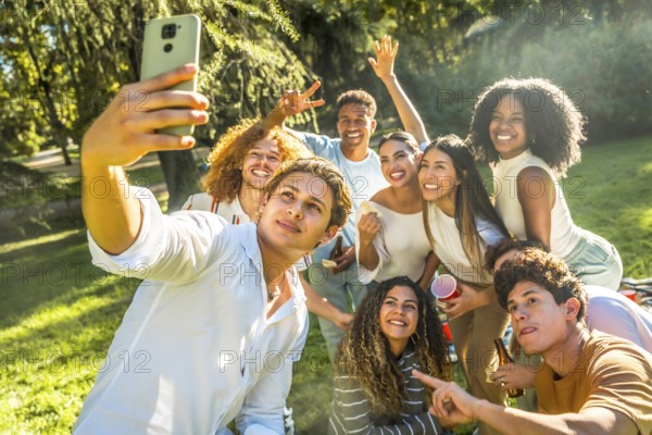 Multicultural young friends taking selfie enjoying a day in a park