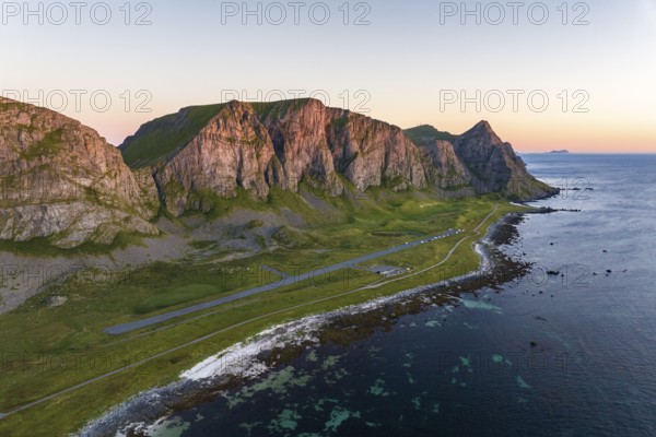 Coast and mountains in the evening light, runway of the abandoned airport, Værøy island, Vaeroy, Lofoten, Norway