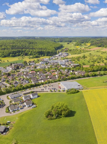 Aerial view of a village surrounded by fields and forests under a slightly cloudy sky, Gechingen, Black Forest, Germany