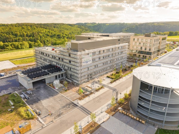 Building complex in a rural setting with several multi-storey buildings and structures, construction of the new hospital health campus Calw, Germany