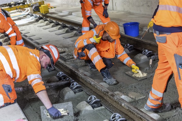 Deutsche Bahn AG track construction at Stuttgart Airport. The last few meters of solid road in the airport tunnel are concreted. This means that all long-distance railway tracks of Project S21 have been laid. Workers lay the rails and concrete the track bed. Stuttgart, Baden-Württemberg, Germany