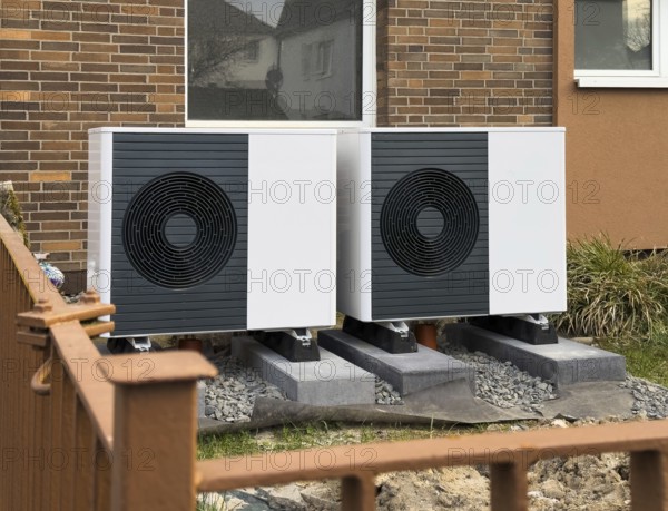 2 heat pumps are installed on an apartment block in a front garden, Hilden, Germany