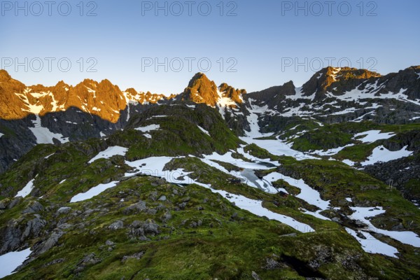 Rocky mountain peaks with snow, at the Trollfjord Hytta, mountain landscape with alpenglow at sunrise, at the Trollfjord, Lofoten and Vesterålen, Nordland, Norway