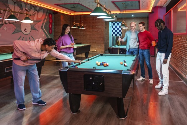 Group of multi ethnic friends enjoying a game of billiards in a vibrant entertainment venue, showcasing leisure and camaraderie