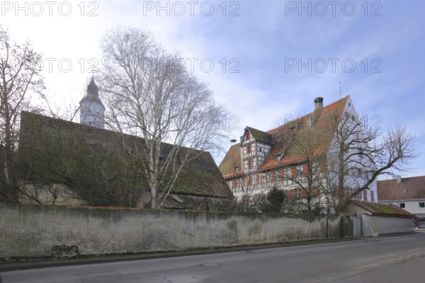 Historic office building built in 1610 with the tower of St Martin's Church, Langenau, Alb-Donau district, Swabian Alb, Baden-Württemberg, Germany