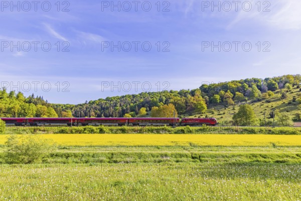 ÖBB RailJet travelling across the Swabian Alb. Idyllic landscape near Lonsee in spring. Lonsee, Baden-Württemberg, Germany