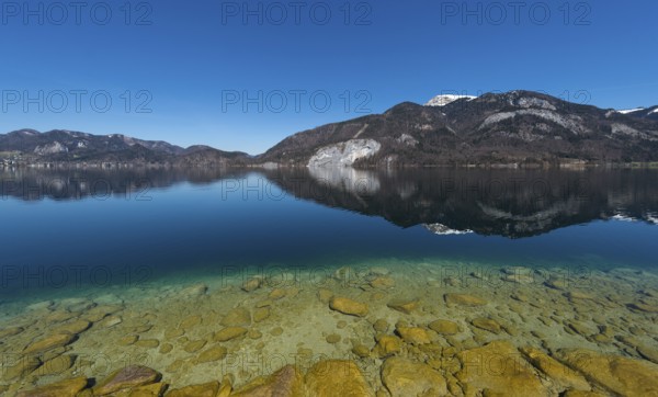 Lake Wolfgang with a reflection of the surrounding mountains, near St. Gilgen, Salzkammergut, Salzburg State, Austria