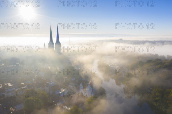Aerial view over the old town and Lübecker Dom of the Hanseatic City of Lübeck in the fog in autumn, fall, Schleswig-Holstein, Germany