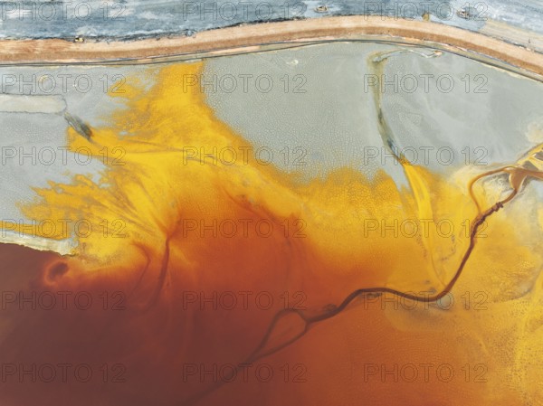 Waste pond in the mineral-rich area of the Rio Tinto mines. The colour is caused by oxidised iron minerals. Aerial view. Drone shot. Huelva province, Andalusia, Spain