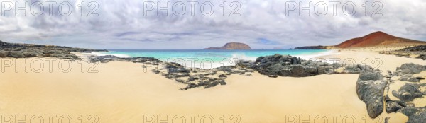 Sandy beach of Playa de las Conchas, volcano Monte Bermeja and island Monta Clara in the background, La Graciosa, Lanzarote, Canary Islands, Spain