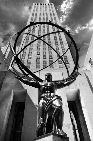 Atlas statue at Rockefeller Centre behind the office building, New York City, USA