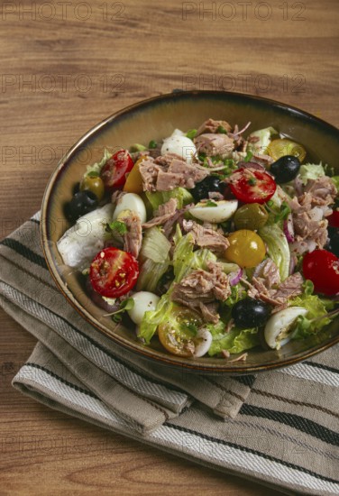Salad with canned tuna, vegetable salad with quail eggs, lettuce, red onion, cherry tomatoes, olives, keto food, healthy food, homemade, no people