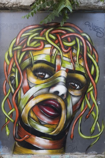 Medusa, female head with hair of colourful snakes, mural in the Anafiotika district, street art, Athens, Greece