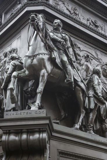 Historical equestrian statue of Frederick the Great at the Forum Fridericianum from 1839-1851, Hussar General Hans Joachim von Zieten in uniform with sword on a horse with eyes wide open and mouth agape from fear and pain, torture, cruelty to animals, artist: Christian Daniel Rauch, Berlin School of Sculpture, transition from Classicism to Realism, bronze, bronze sculpture, pedestal, portrait, imposing, equestrian monument, equestrian statue, sculpture, Berlin Mitte, City of Berlin, Germany