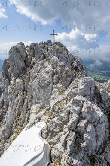 Mountain peak Ackerlspitze with summit cross, mountaineer on the last ascent to the summit, Wilder Kaiser, Kaiser Mountains, Tyrol, Austria