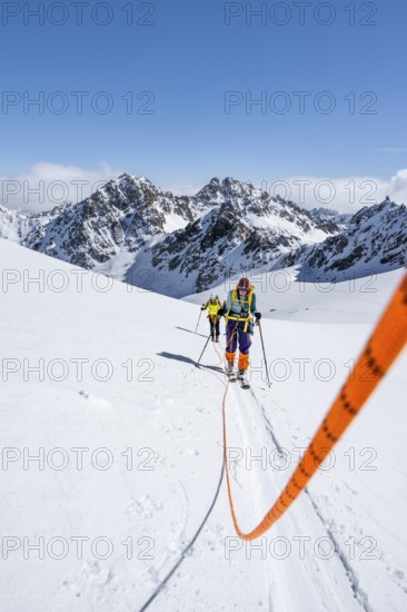 Ski tourers walking on a rope over the Vadret da Porchabella glacier, Bündner Haute Route ski tour, Albula Alps, Rhaetian Alps, Grisons, Eastern Switzerland, Switzerland