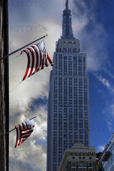 Waving US flag with Empire State Building, New York City, USA