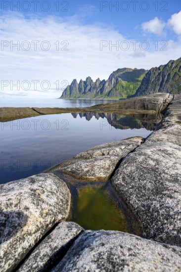 Reflection in a tidal pool, rocky coast of Tungeneset, Devil's Teeth, Okshornan, Ersfjorden, Senja Island, Troms, Norway