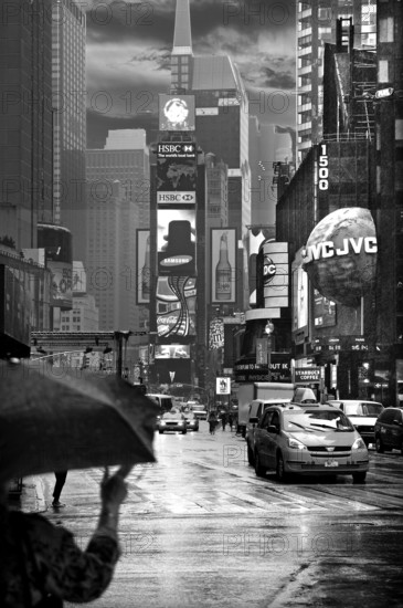 Evening Times Sqaure with illuminated advertising in the rain, New York City, USA