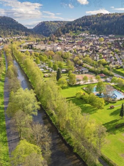 River runs through green landscape near town in mountainous surroundings, Bad Liebenzell, district of Calw, Black Forest, Germany