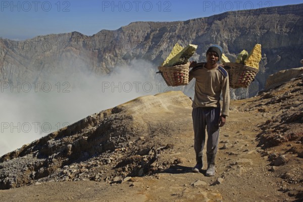 Asia, Indonesia, Java, Volcanoes in Bromo-Semeru National Park, Workers transporting sulphur, Java, Indonesia