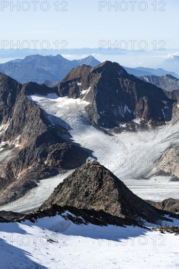 At the Wilder Freiger summit, picturesque high mountain landscape with snow, view of the Übeltalferner glacier and rocky mountain peaks Becher with Becherhaus and Königshofspitz, Stubai Alps, South Tyrol, Italy