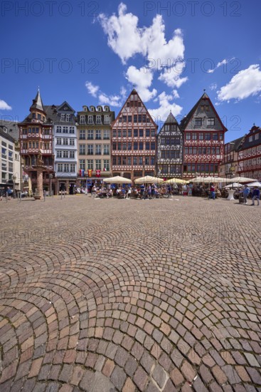 Saturday hill with half-timbered houses on the Römerberg town hall square under a blue sky with cumulus clouds in Frankfurt am Main, Hesse, Germany